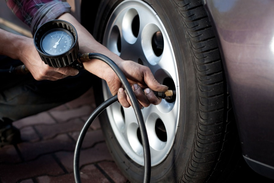 What is the purpose of measuring the tire pressure of a car?
