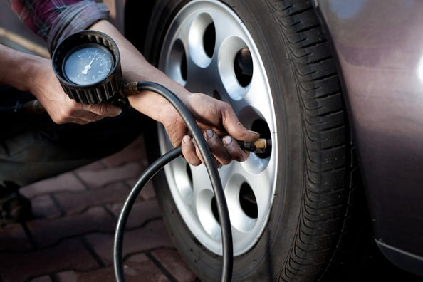 What is the purpose of measuring the tire pressure of a car?
